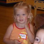 at Build A Bear, Kaylin rubbing her bears heart for a smile